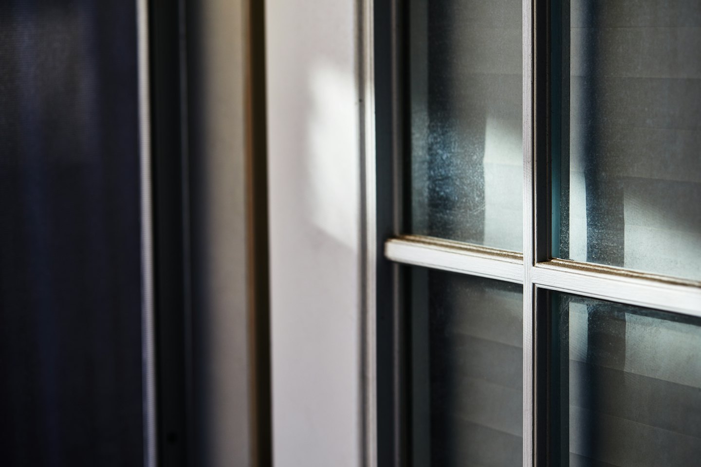 Modern glass window with a silver frame on a wall.